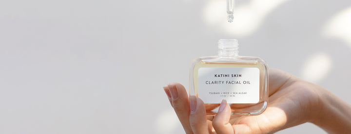 Hand holding Katini Skin's Clarity Facial Oil