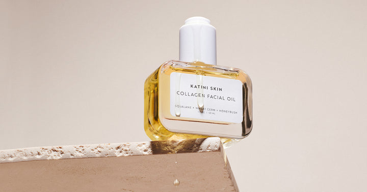 Katini Skin's Collagen Facial Oil with oil dripping on a platform