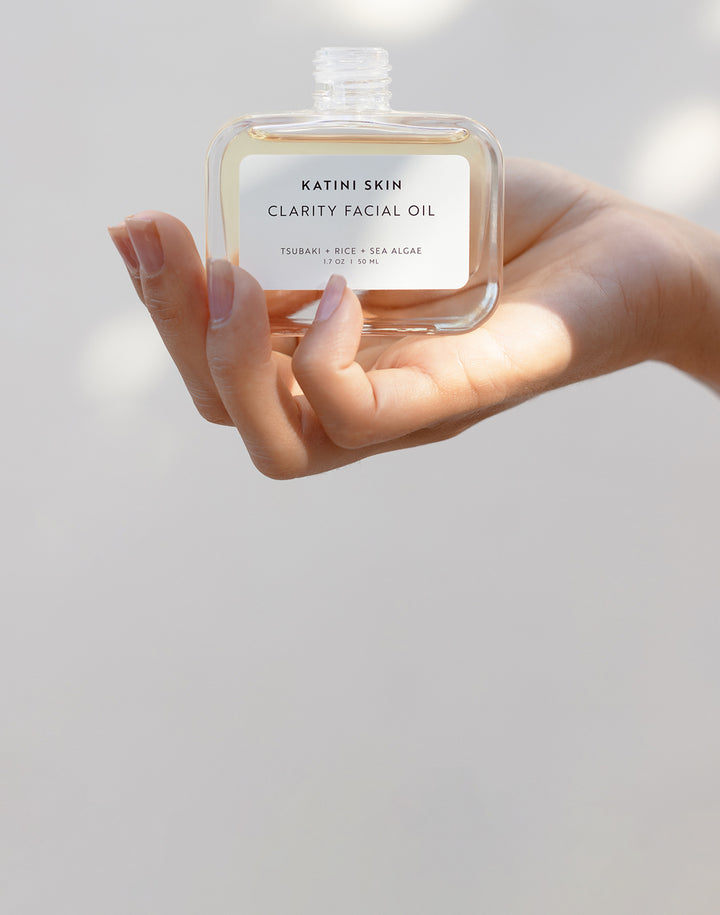 Hand holding Katini Skin's Clarity Facial Oil