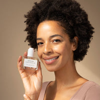 Model holding the Collagen Facial Oil from Katini Skin